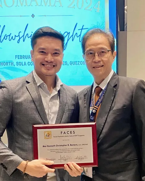 Dr. Romero receiving his FACES fellowship certificate from a mentor