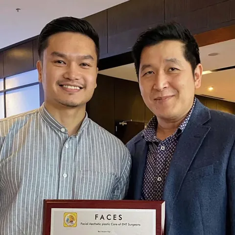 Dr. Romero with a mentor, holding his FACES certificate