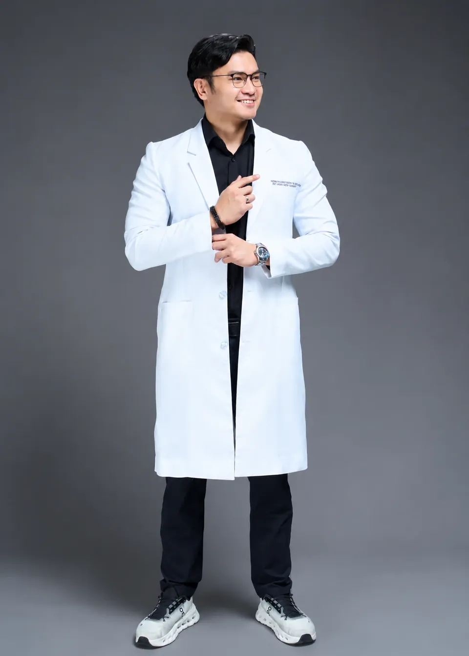 Dr. Ken Romero standing, in a full-length white coat