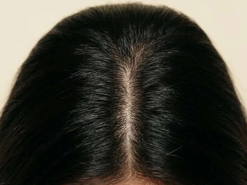 Model photograph: a centre part in thick dark hair